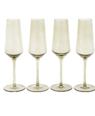 Four champagne flutes with gold bases on a white background