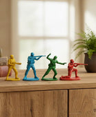 Four toy soldiers in different colors on a wooden surface with a blurred background