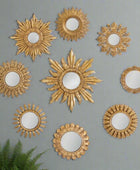 Set of gold decorative mirrors with sunburst designs on a white background