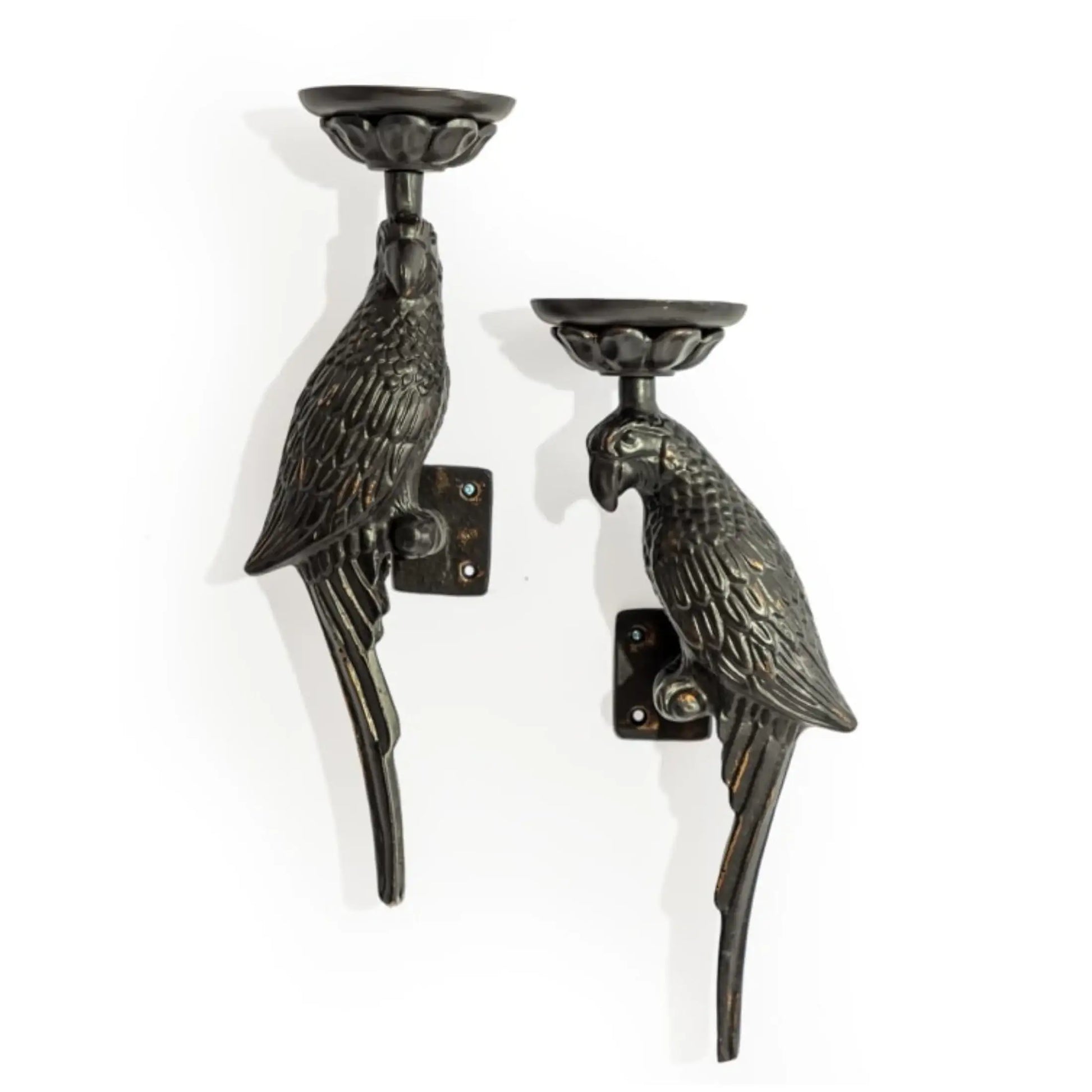 Two parrot-shaped wall candle holders on a white background