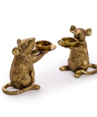 Two brass mouse candle holders on a white background