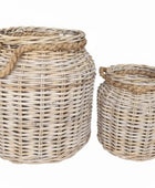 Two wicker baskets with handles on a white background