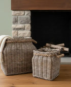 Two woven baskets in front of a stone fireplace.
