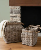 Wicker baskets with a blanket in front of a stone fireplace.