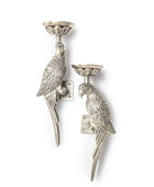 Two silver parrot-shaped candle holders on a white background