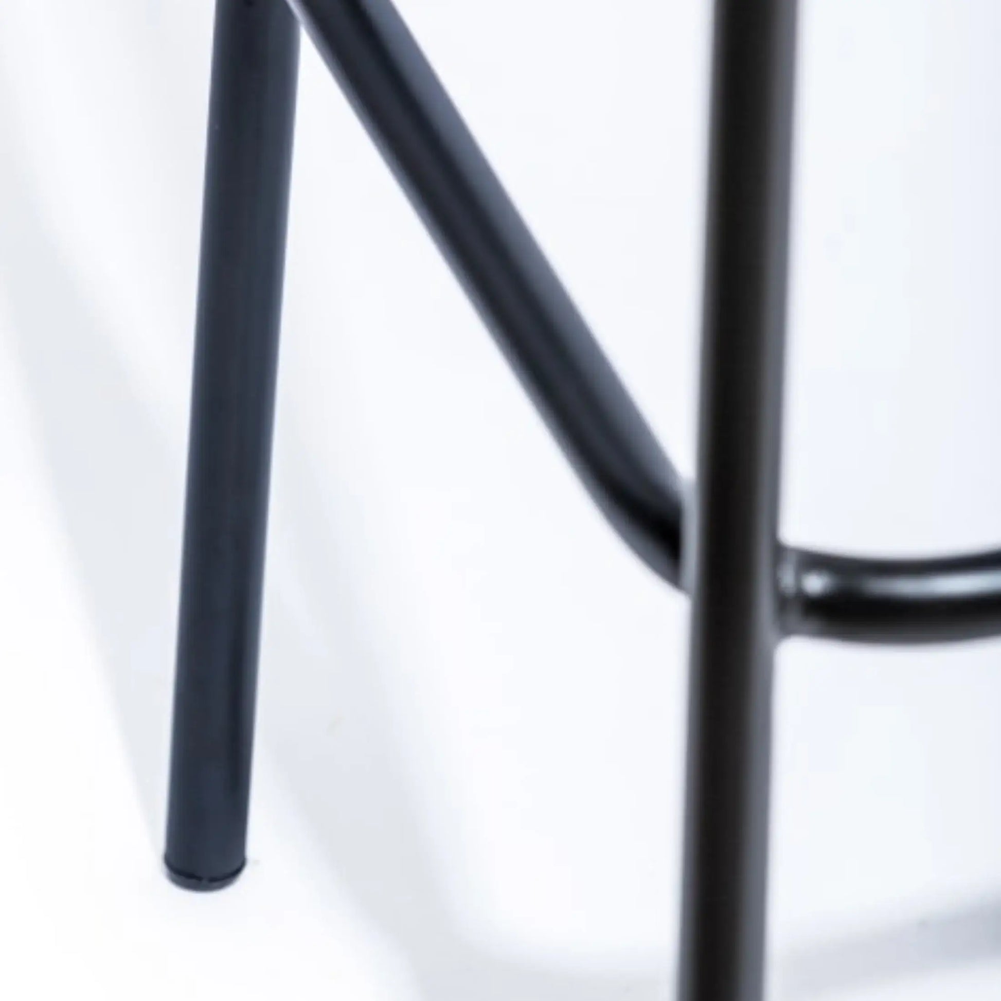 Close-up of a black metal stool on a white background