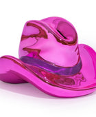 A glossy, metallic pink cowboy hat sculpture or decorative object, shown on a clean white background.