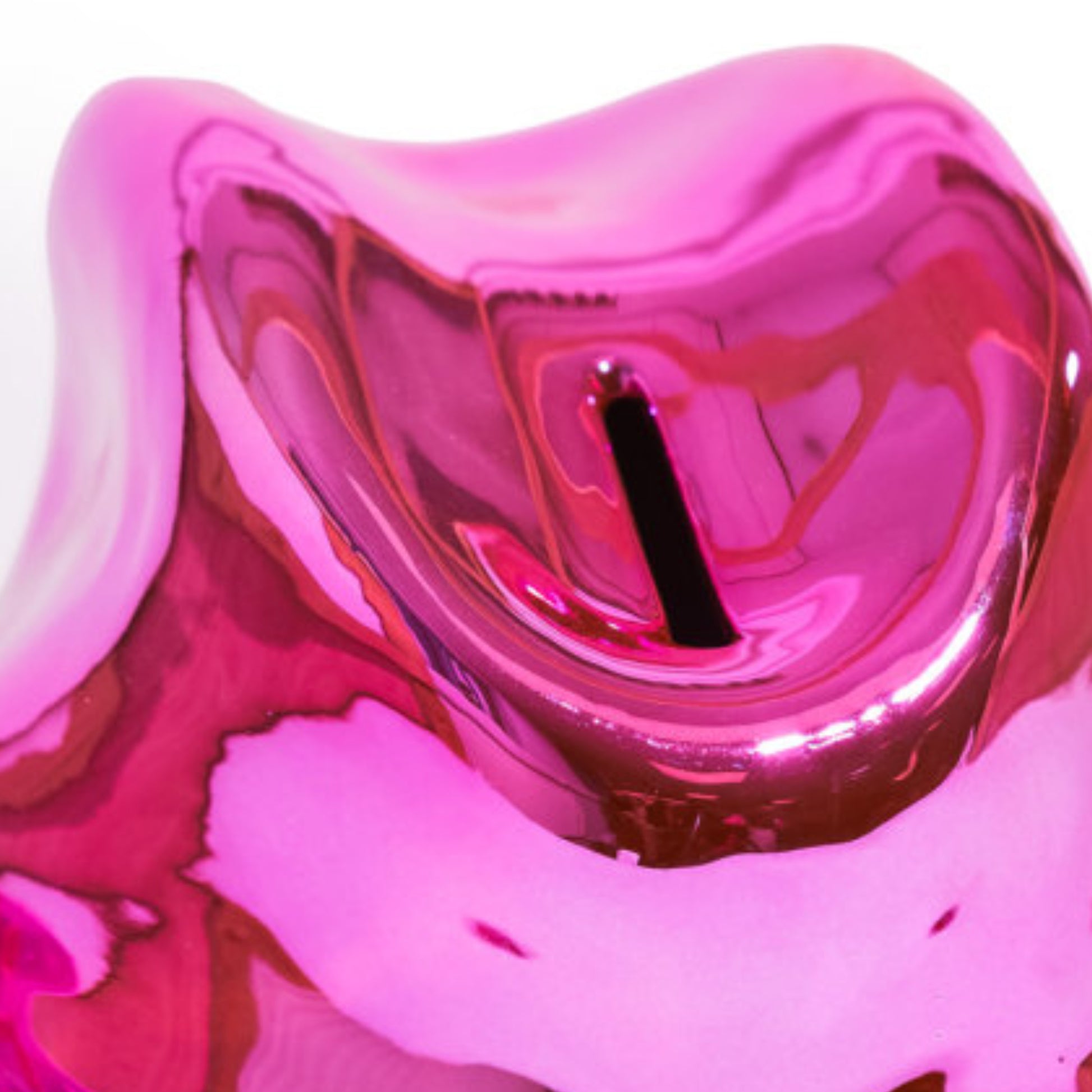 A close-up of a glossy, highly reflective pink ceramic or glass vessel with a black central stem or rod, set against a plain white background.