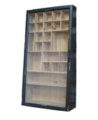 A wall-mounted wooden display cabinet with a black frame and multiple interior compartments, shown against a brick wall.