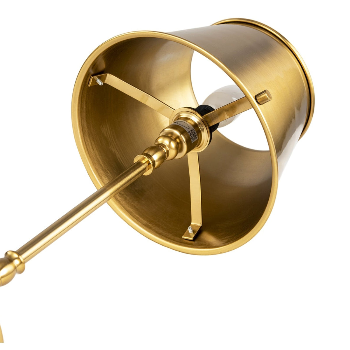 Close-up of a brass wall sconce showing the interior of the shade, mounting brackets, and part of the metal stem against a white background.