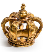 A miniature gold crown figurine with ornate details, photographed on a clean white background.
