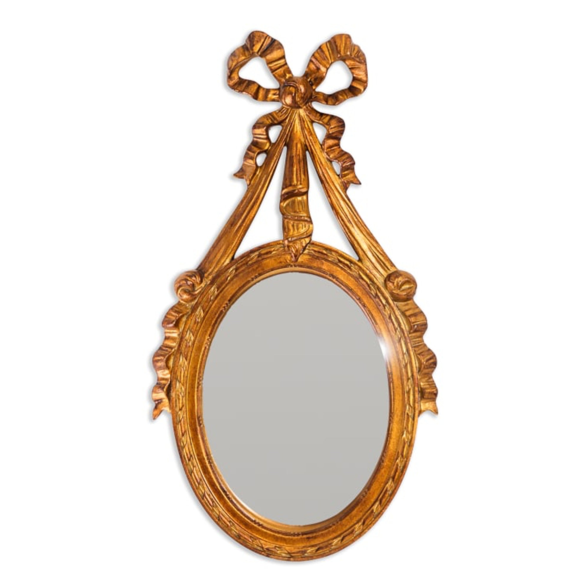 Decorative gold mirror with a bow-shaped design on a white background