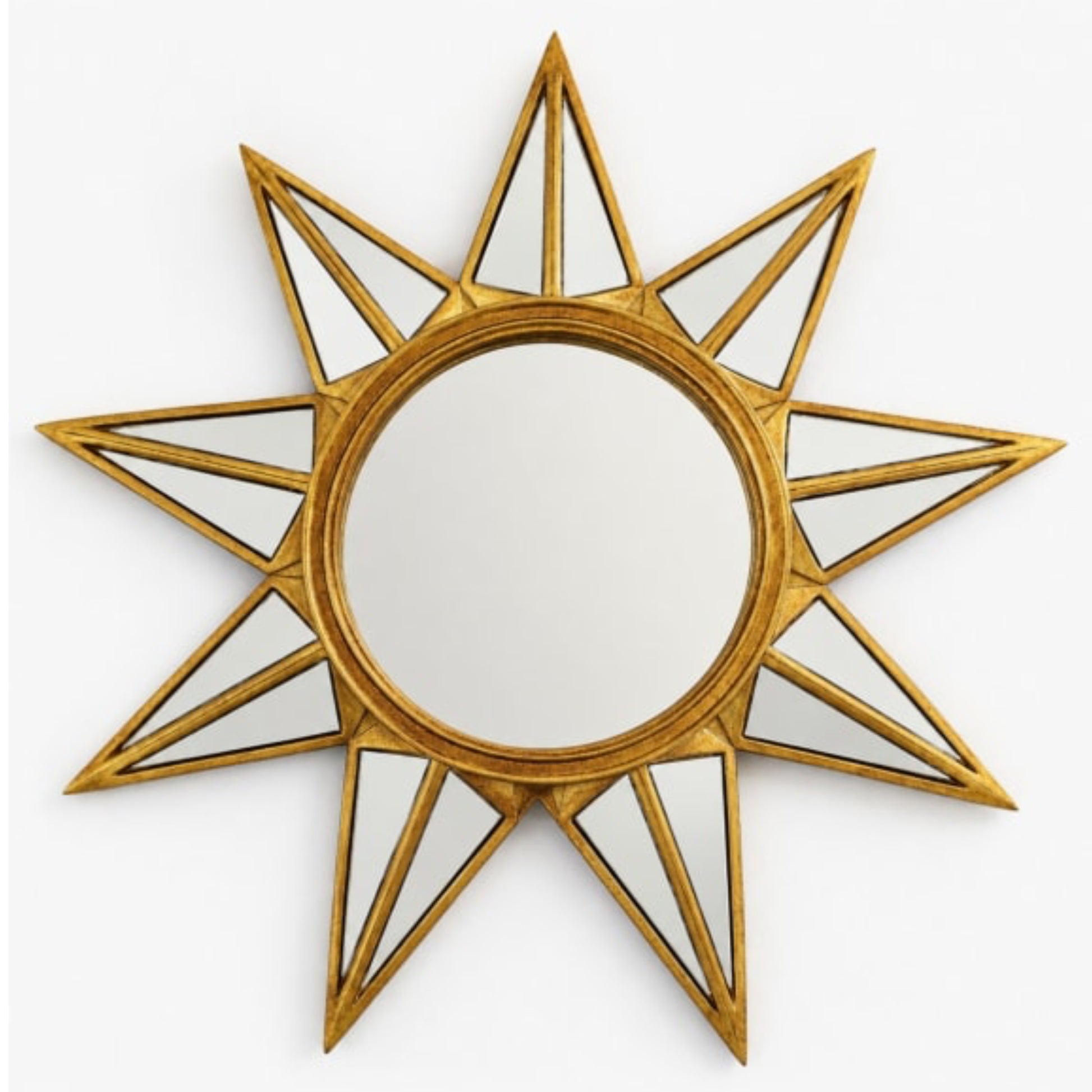 Decorative sun-shaped mirror with gold frame on a white background