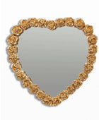 Heart-shaped mirror with gold rose frame on a white background