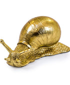 Gold snail sculpture on a white background