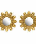 Two gold sunburst mirrors on a white background