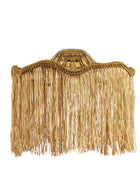 A bohemian-style pendant light with a natural tan raffia fringe shade, a gold-toned metal collar, and a frosted glass bulb holder, suspended from a white cord against a white background.