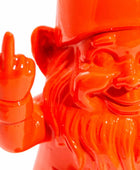 Orange gnome figurine making a middle finger gesture on a white background