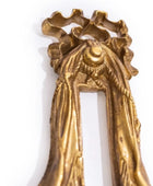 Decorative gold keychain with intricate design on a white background