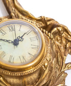 Decorative gold clock with intricate designs on a white background