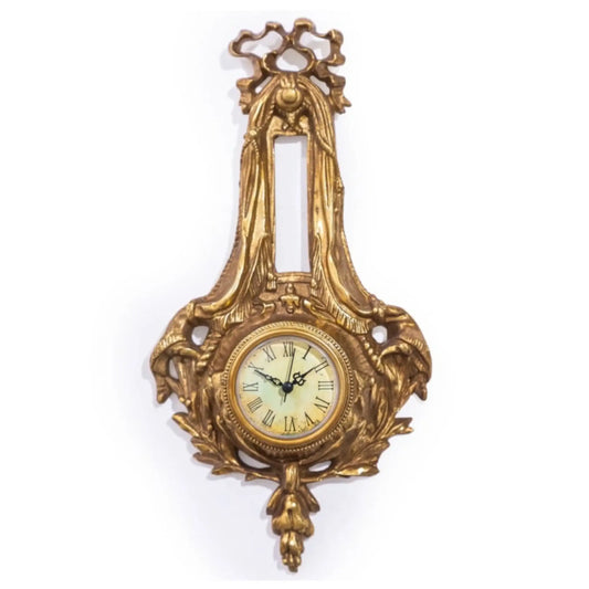 Decorative gold wall clock with intricate designs on a white background