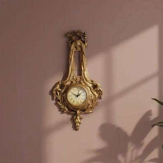 Decorative gold wall clock on a pink wall with plant shadows