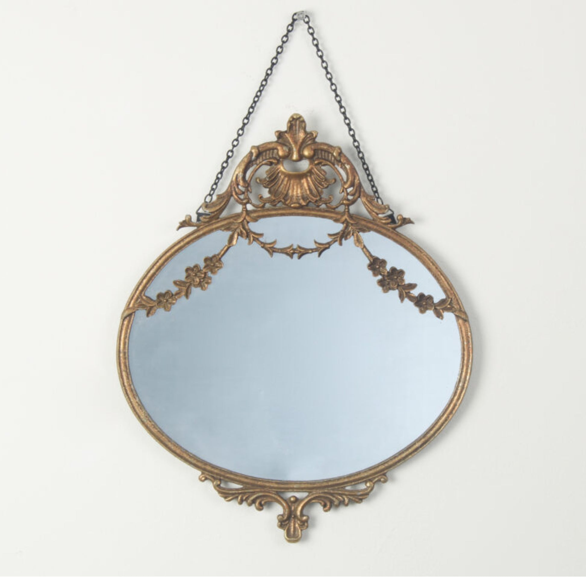 Decorative wall mirror with gold frame and chain on a white background