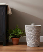 Woven basket with a lid on a white background