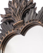 Decorative mirror with intricate bronze frame on a white background