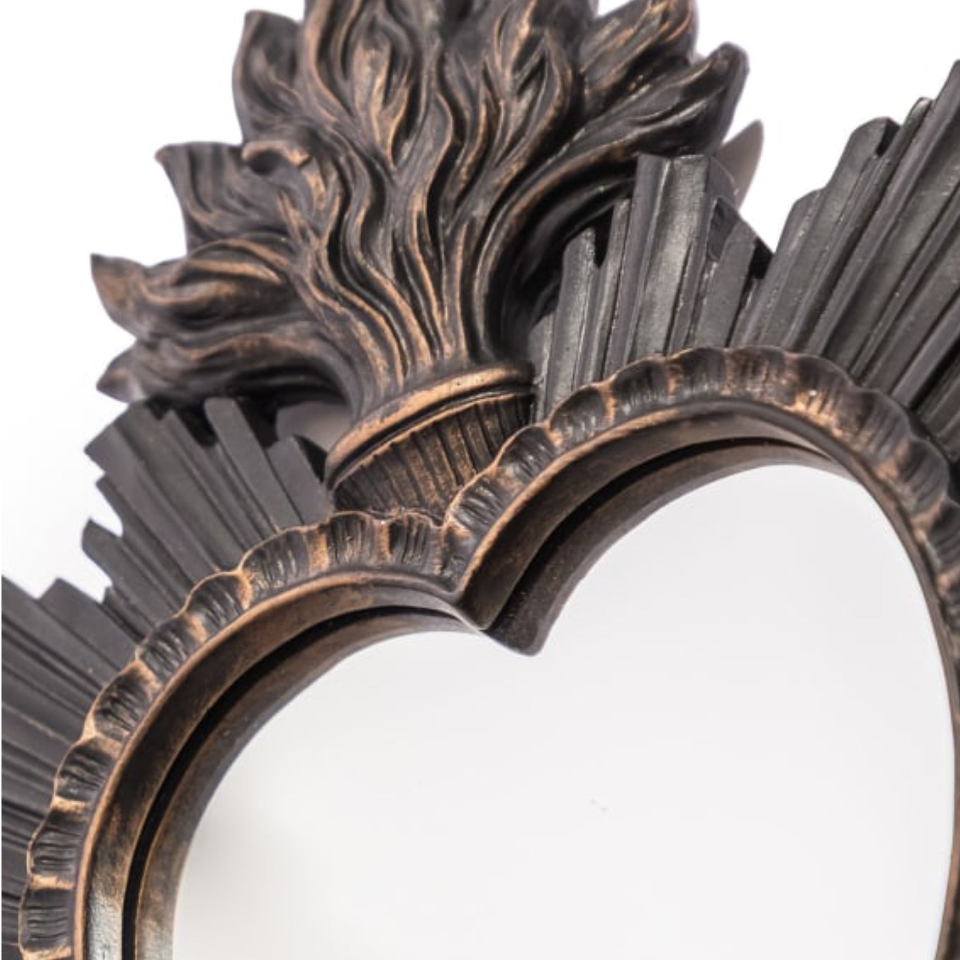 Decorative mirror with intricate bronze frame on a white background