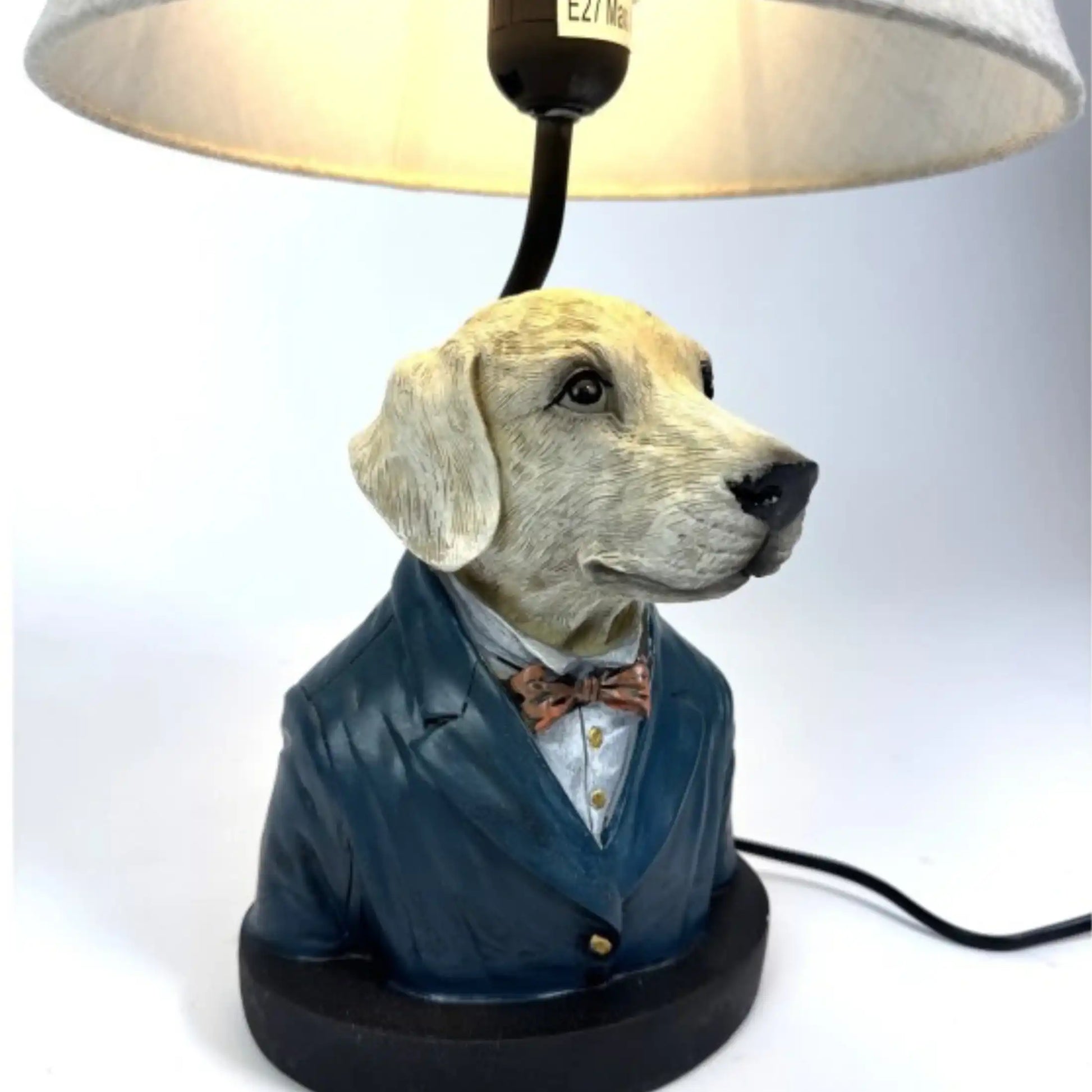 Dog-shaped lamp with a suit and bow tie on a white background