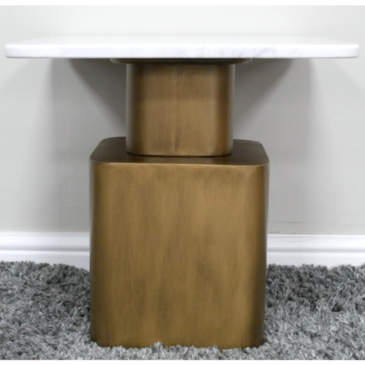 Close-up of a table with a gold metal base on a gray carpet.