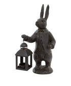 Statue of a rabbit in a suit holding a lantern on a white background