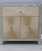Wooden cabinet with sunburst pattern on a plain background