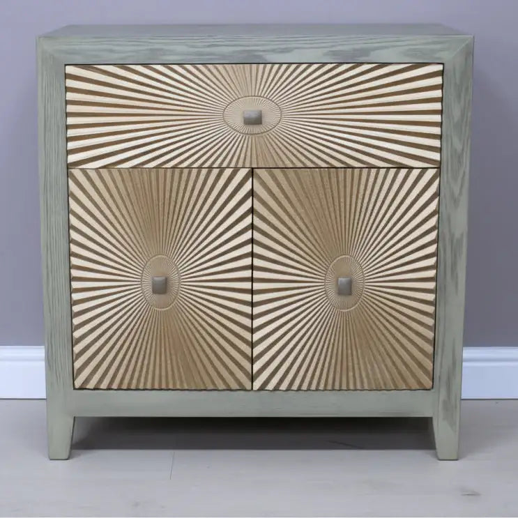 Wooden cabinet with sunburst pattern on a plain background