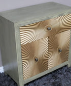 Wooden side table with gold sunburst design on a gray carpet