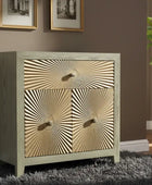 Wooden cabinet with gold sunburst design on doors in a room setting.
