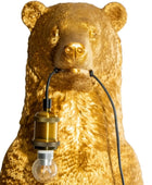 Gold bear-shaped lamp with a visible light bulb on a white background