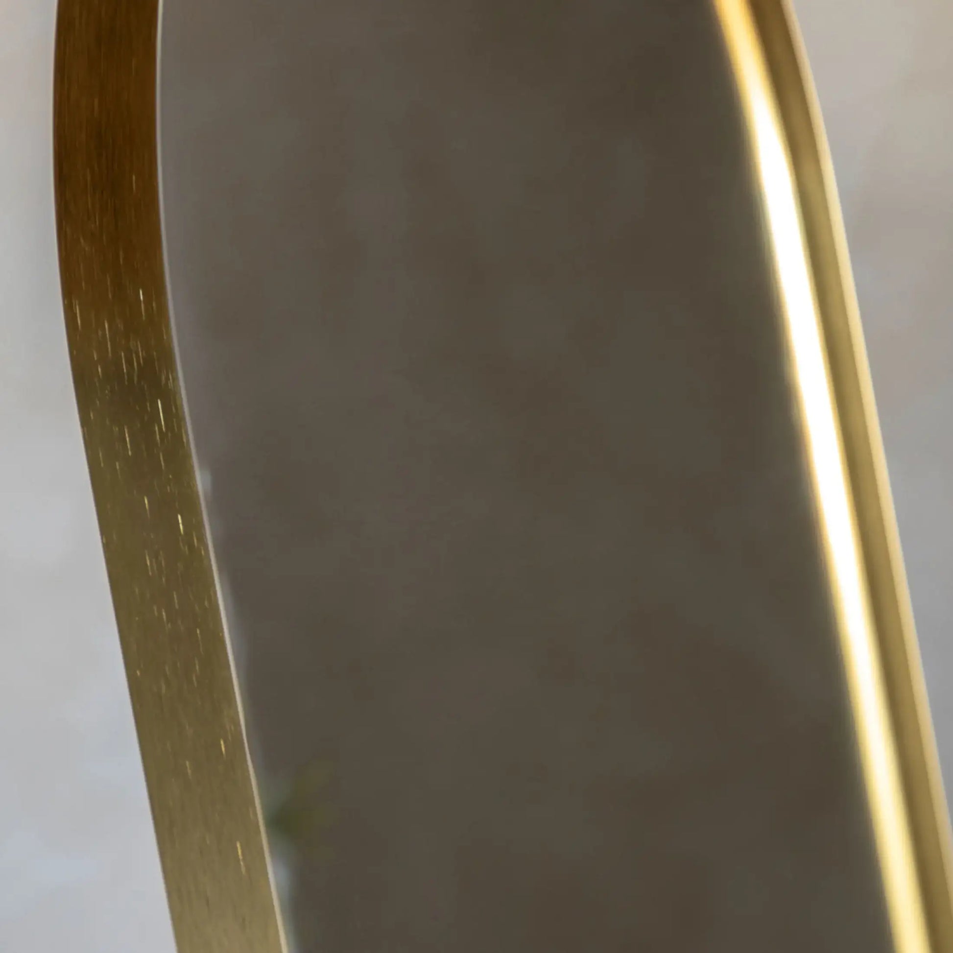 Gold-framed mirror on a white background