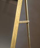Wooden easel against a dark background