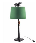 Table lamp with green shade and turtle design on a white background