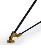 Brass lamp arm with black cable on a white background
