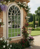 Arched window-style mirror on a brick wall