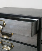 Gray wooden dresser with brass handles on a white background