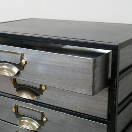 Gray wooden dresser with brass handles on a white background
