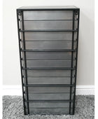 Metal bookshelf with multiple shelves on a gray carpet against a white wall