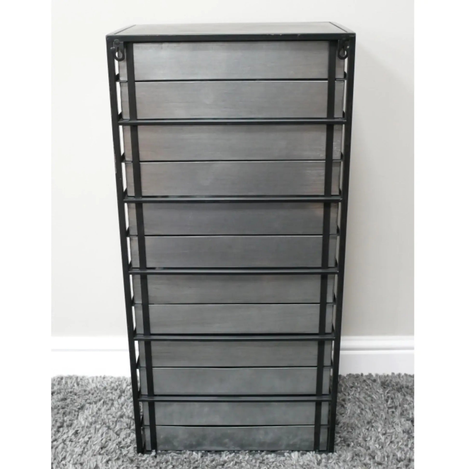 Metal bookshelf with multiple shelves on a gray carpet against a white wall