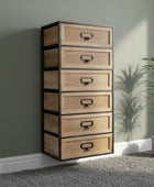 Wooden drawer unit with black metal frames and handles on a gray carpet.