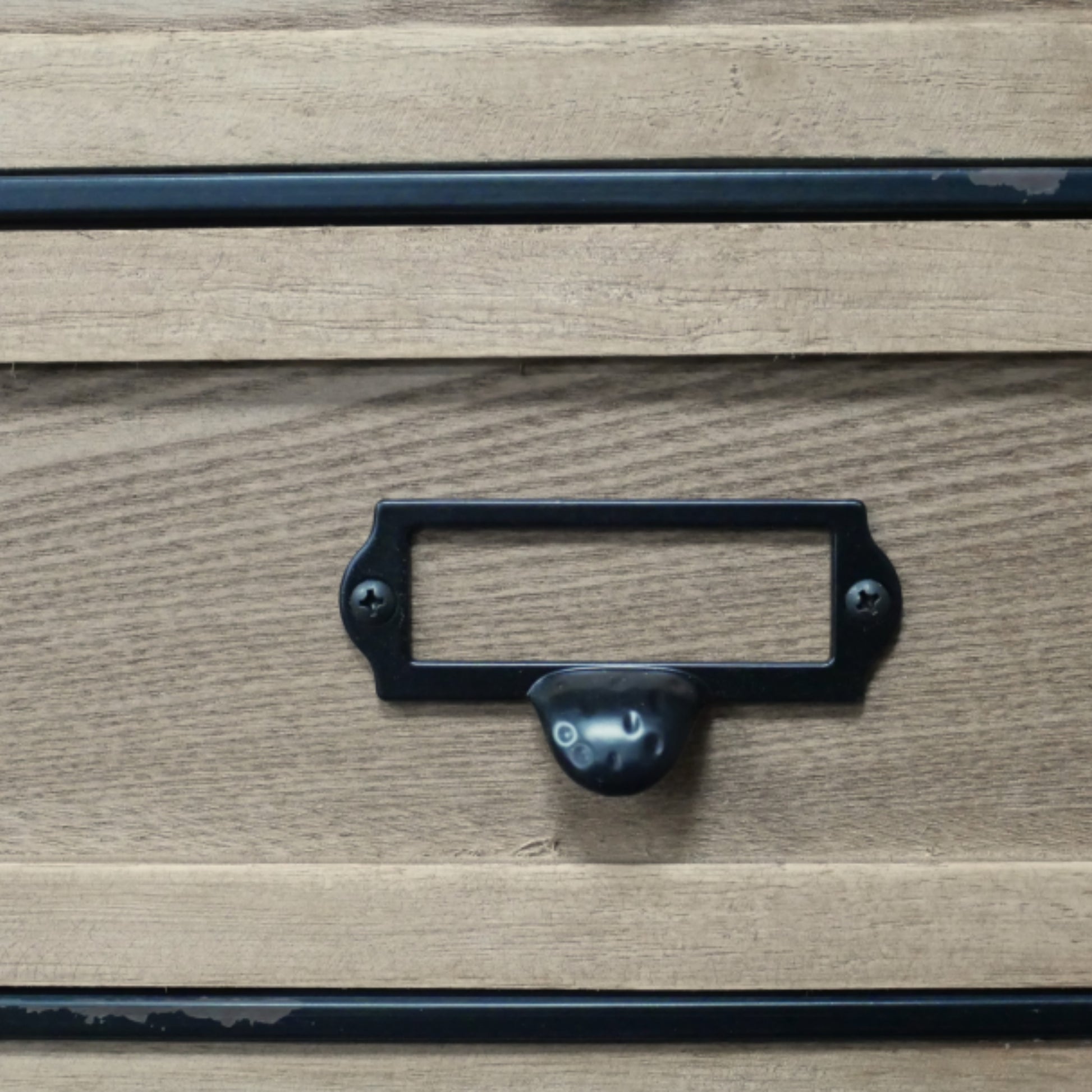 Wooden drawer with a black metal handle