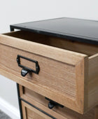 Wooden drawer with metal handle on a piece of furniture.